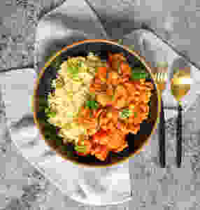 chickpea and courgette stew with couscous in bowl