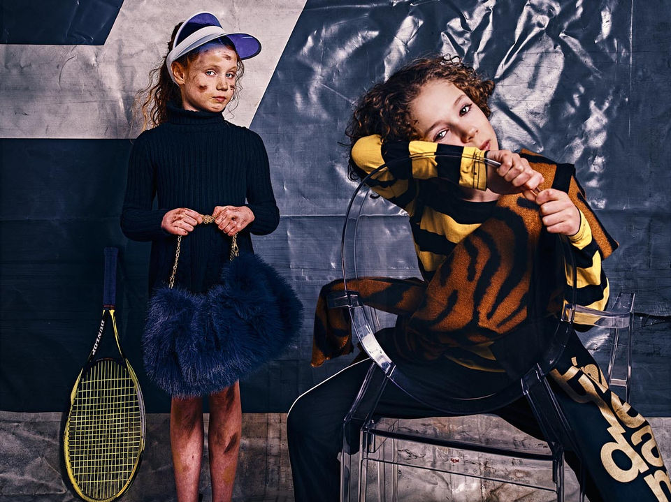Two kids posing with oversized fashion props