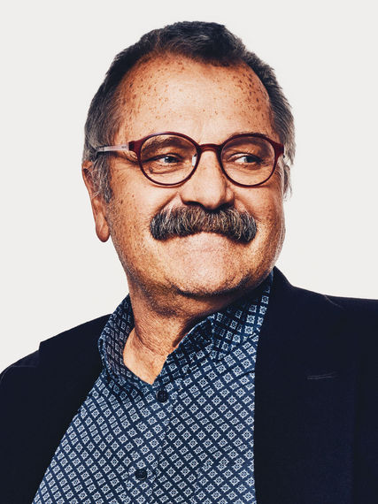 Sympathetic and professional branding portrait of a male expert with glasses, suitable for "About Me" pages and press kits