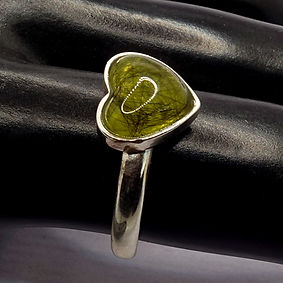 Black pet fur in yellow resin in a hear-shaped silver ring