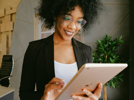 An image of a millennial in the workplace on an ipad