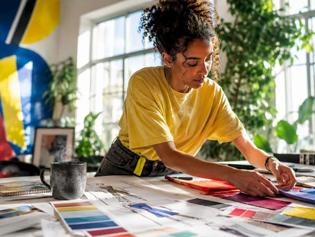 Apparel designer arranging colorful fabric swatches