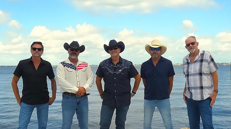 Five men in cowboy hats pose on a dock by the water