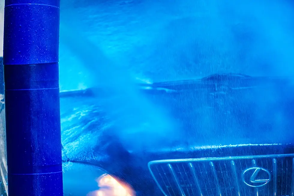 Car being washed in a Petit Auto Wash Equipment in-bay system