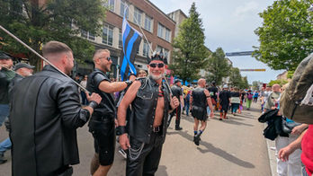 Leather subculture participants at a Pride Month parade.