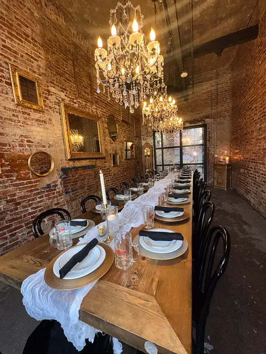 Long dining table set for an event, adorned with vintage decor, baltimore event spaces.