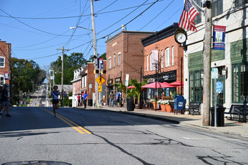 Mount Airy street with shops, people, and American flag