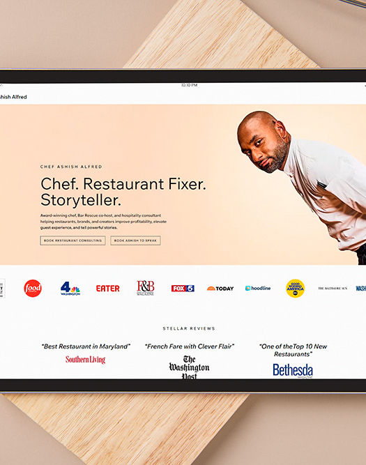 Tablet displays "Chef, Restaurant Fixer, Storyteller" website, surrounded by kitchenware.