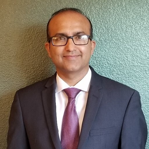 Professional at an AI innovation company wearing a suit.