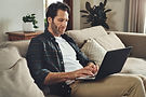 Man on couch working on laptop