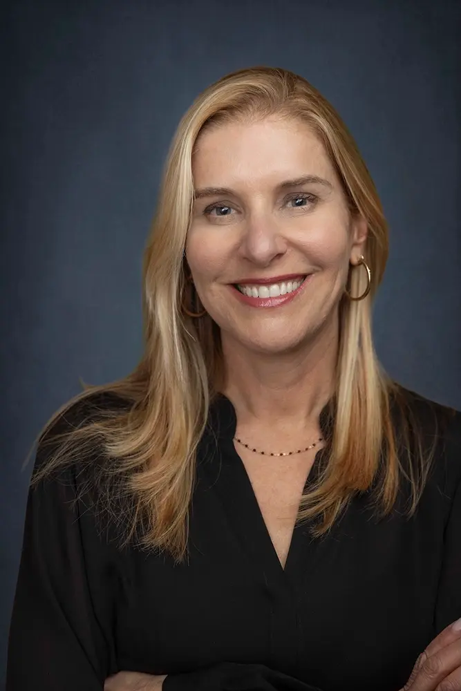Smiling woman with long blonde hair in a black top