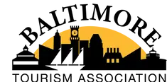 Silhouette of city buildings with clock tower and golden arch background