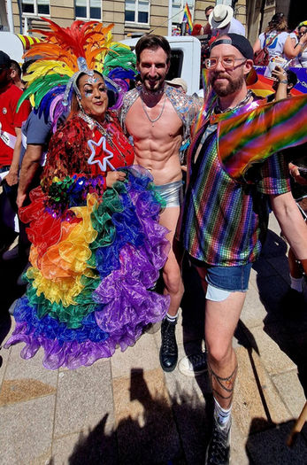 People in colorful rainbow outfits celebrate Pride Month.
