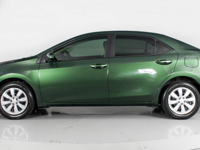 Green car parked against a plain white background; Dash Auto