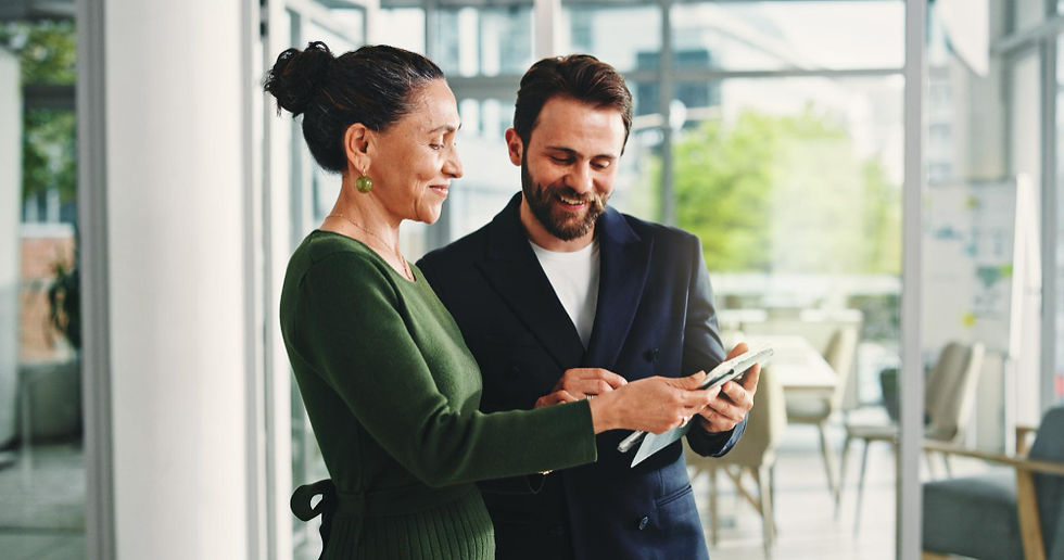 Two professionals discussing AI strategy consulting on a tablet.