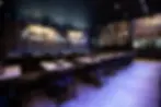 Restaurant interior with tables and a neon sign that says I am someone special.