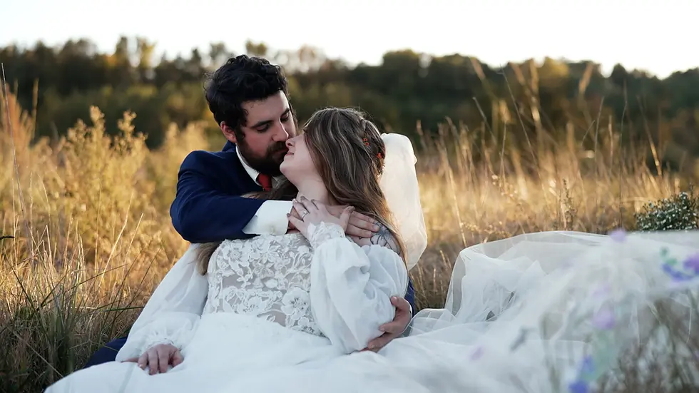 Couple kissing, bride and groom embracing in a field during wedding videography dmv