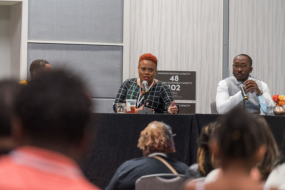 Panelists speaking at a seminar event.