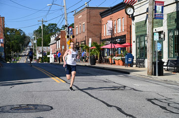 Mount Airy Mile runner on town street
