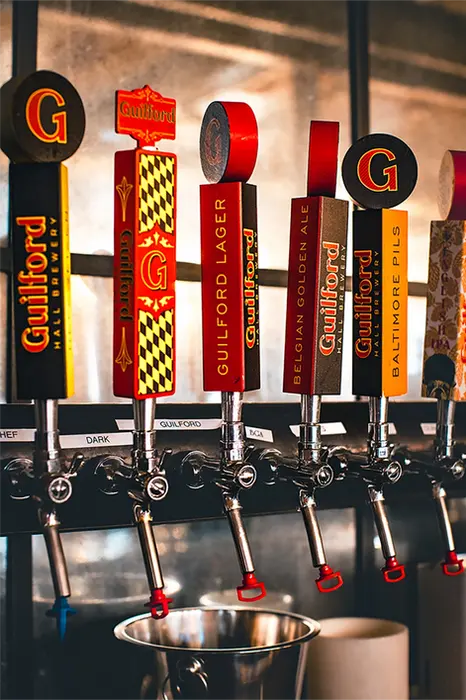 Guilford Hall Brewery beer taps with Guilford Lager and Baltimore Gold labels