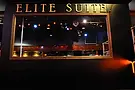 Elite Suite sign over a window overlooking a dim, empty club area.