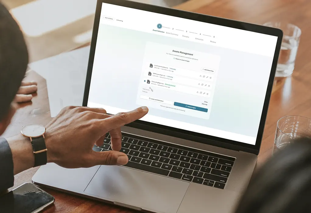 Person pointing at AI workflow automation on a laptop.
