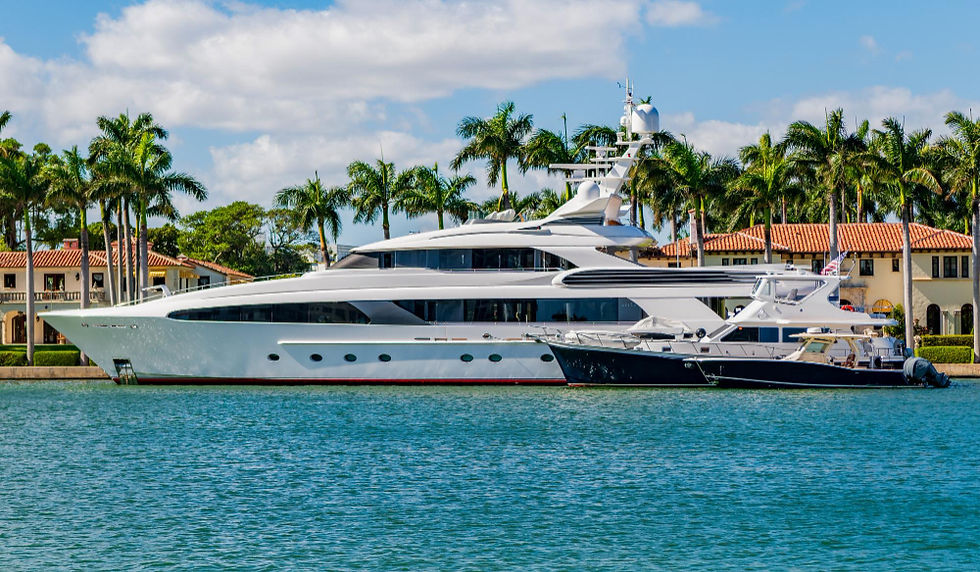 Large white luxury yacht docked in a tropical harbor