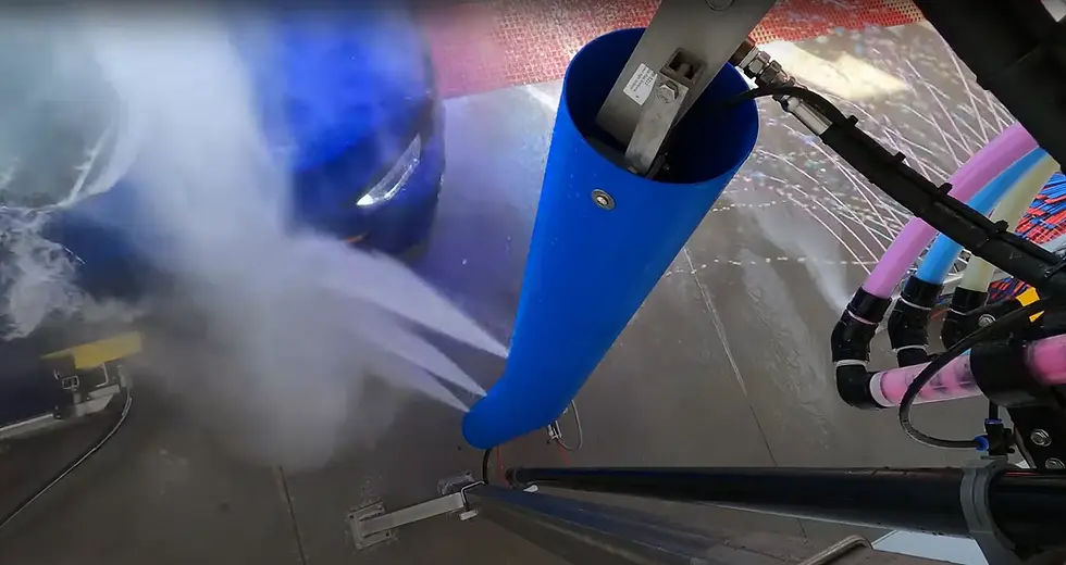 Auto wash equipment spraying water.