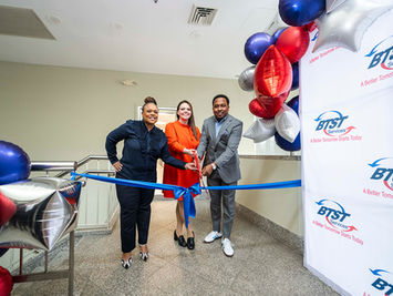 BTST Services ribbon cutting ceremony with team members
