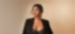 Woman in black blazer and lace top