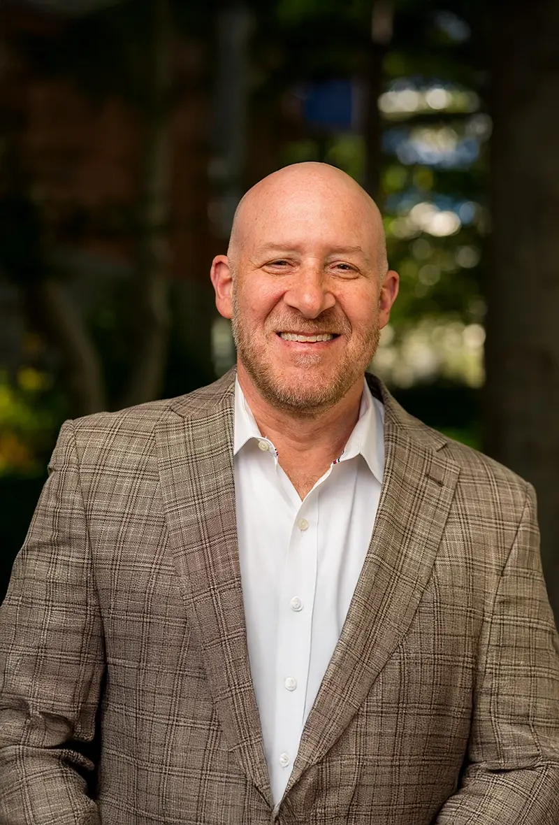 Smiling bald man in a patterned suit jacket