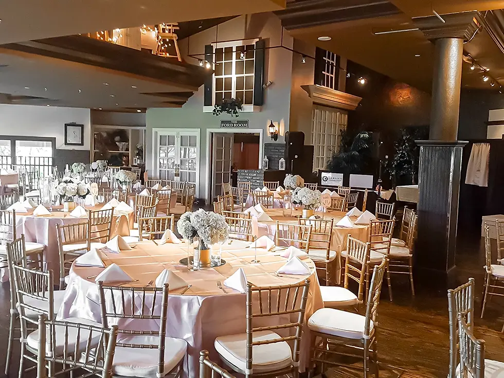 Elegant dining room set for an event with round tables and decor.