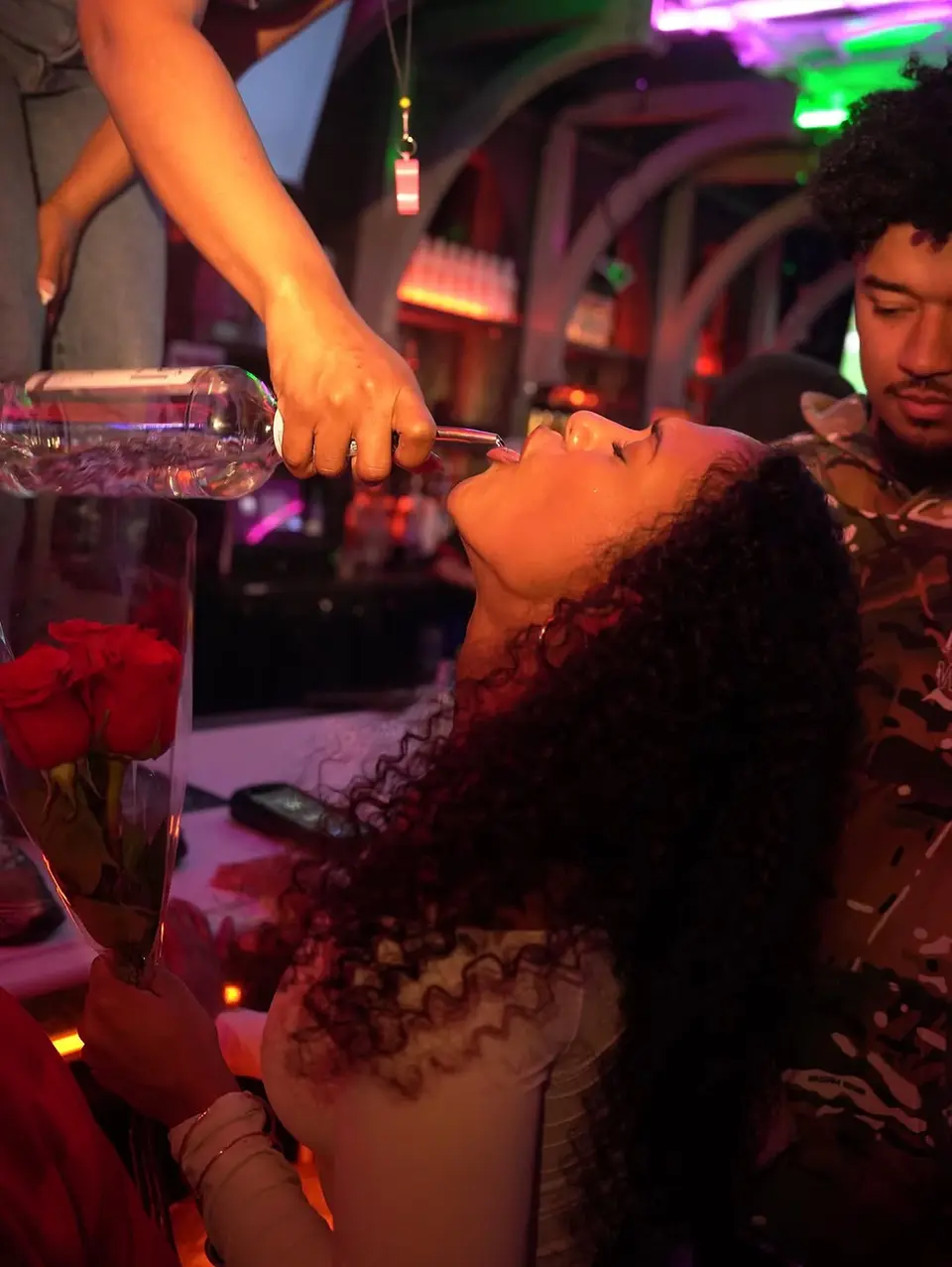 Person drinking liquor from a bottle in a bar, dev-mugshots