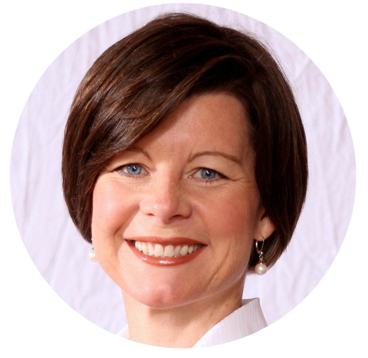 Smiling woman with short brown hair for Our Team profile