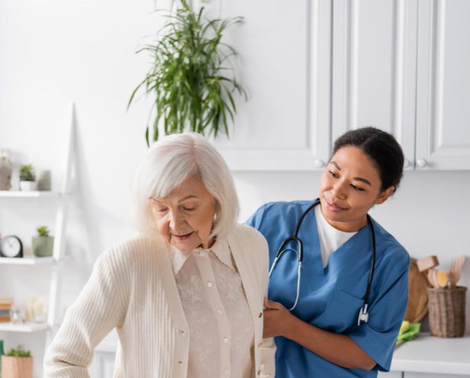 Elderly woman with walker helped by healthcare worker