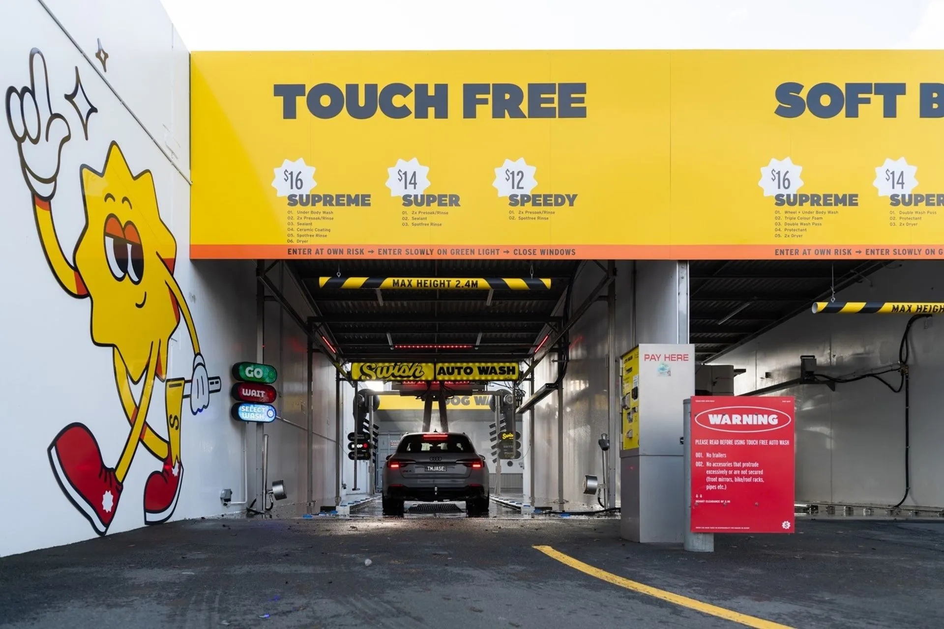 Car entering a touch-free car wash at Petit Auto Wash Equipment.