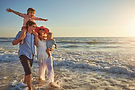 Family on beach at sunset, ideal for Ocean City vacation rentals