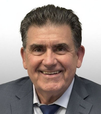 Smiling man in a suit for the About page.