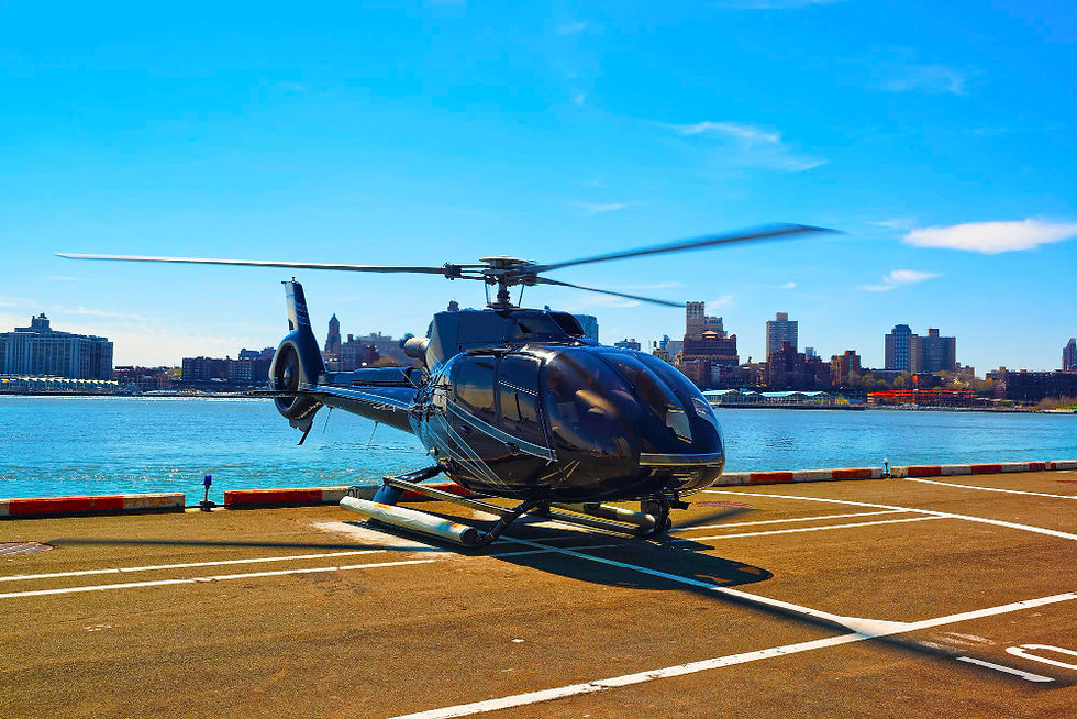 Black helicopter on a helipad with a city skyline view