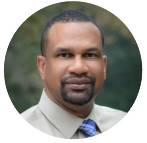 Professional headshot of a team member with a goatee.
