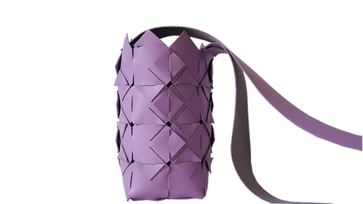 Lilac woven crossbody bag with diamond pattern and long strap, displayed against a transparent background.