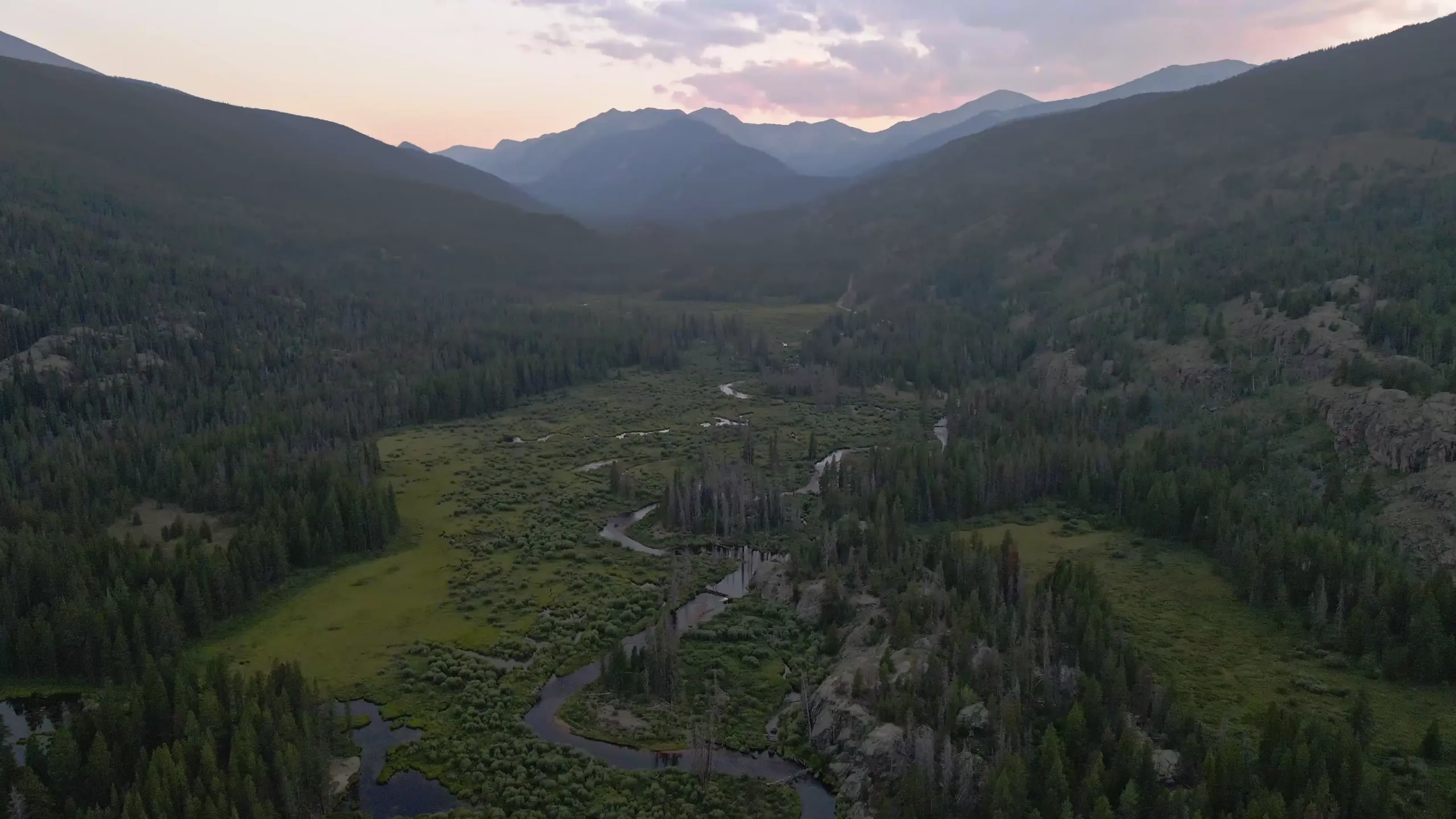 An aerial view of Homestake Valley's forest, wetlands, and surrounding mountains