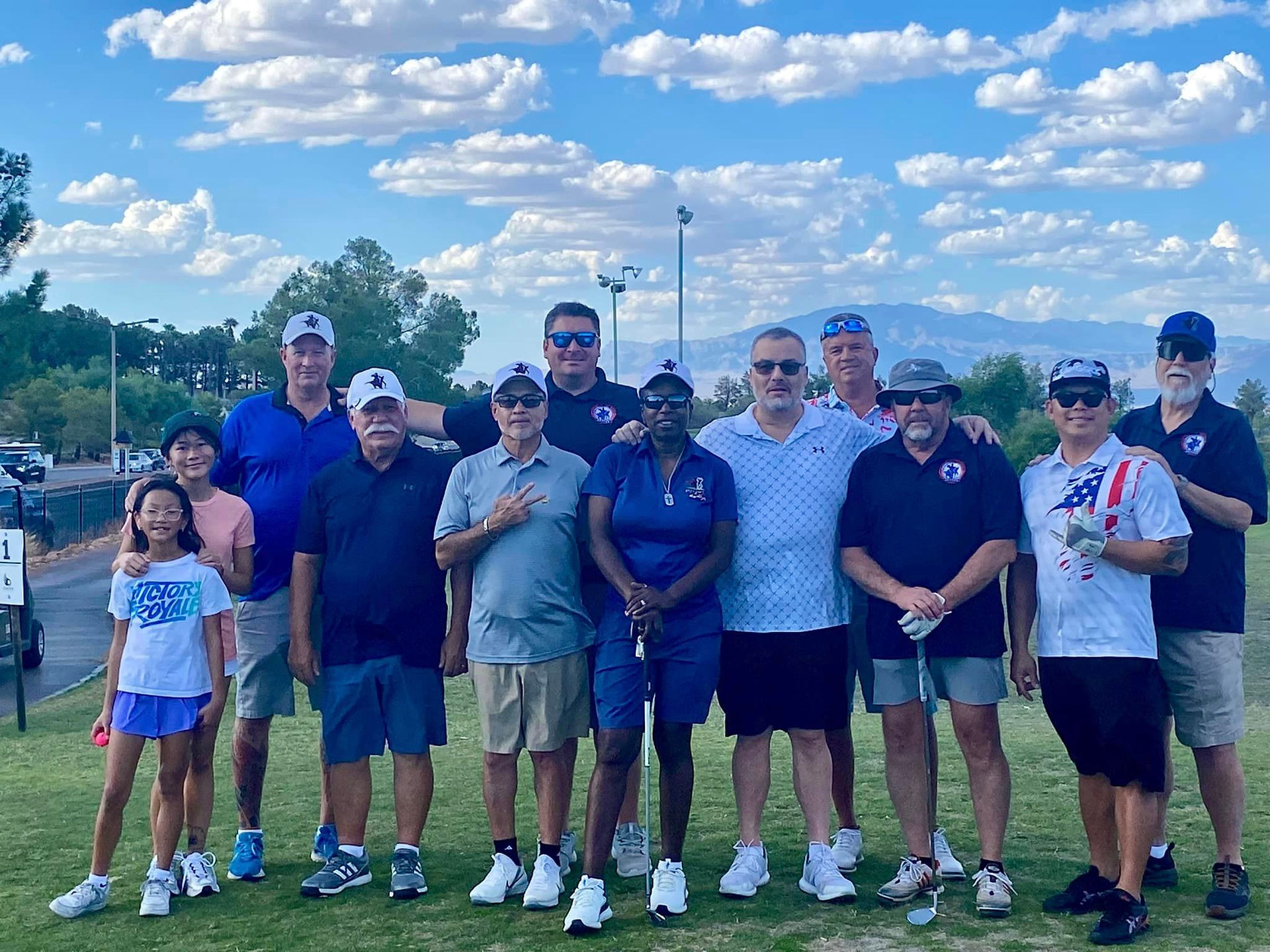 Group of golfers on the green posing for a picture