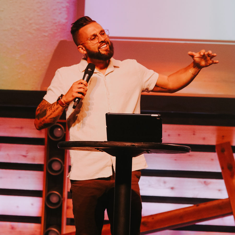 Preston speaking on stage during a leadership event