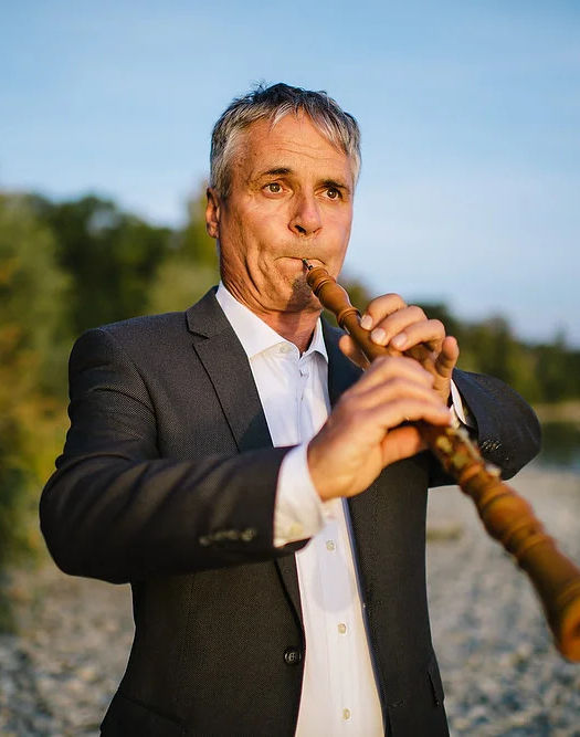 Baroque oboe player on the beach