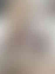 Round table with organized crafts: scissors, markers, and notebooks in compartments. Beige poufs on a rug background.