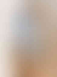 Organized drawer with labeled mesh bags containing various items, on wooden floor. Bags are white with colored zippers.