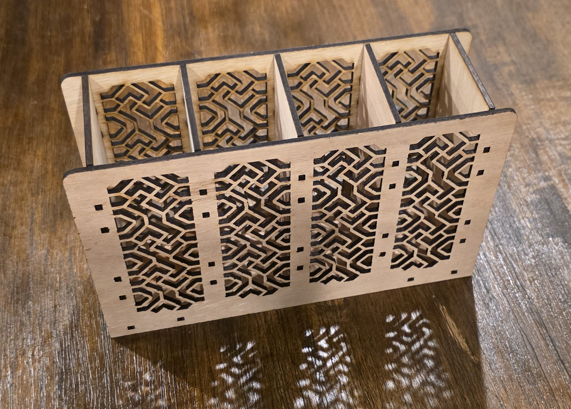 Wooden remote controller organizer with laser-cut patterns