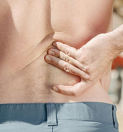 Patient rubbing his back due to low back pain