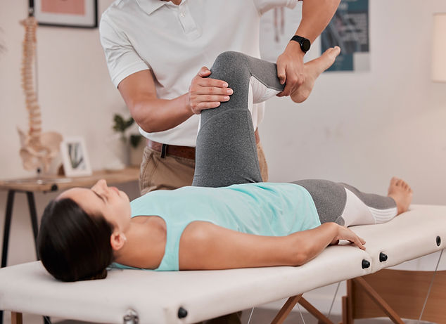 Physiotherapist working on the knee of a patient.jpg